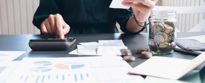 Stressed woman calculating expenses and holding a receipt