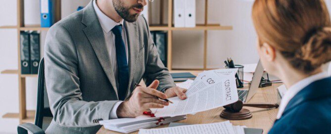 Lawyers discussing a contract at a workspace